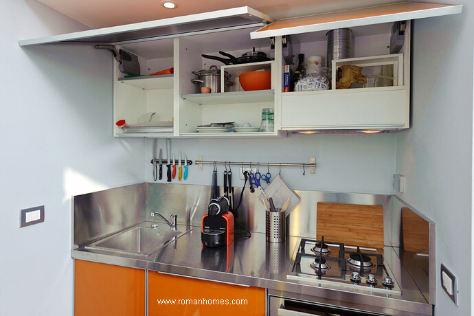 Closer view of the kitchen, showing the cupboard and its full equipment