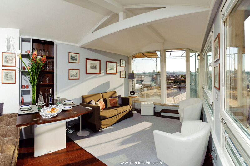 The sitting-dining room of the penthhouse seen from the kitchen, on the way to the main panoramic terrace