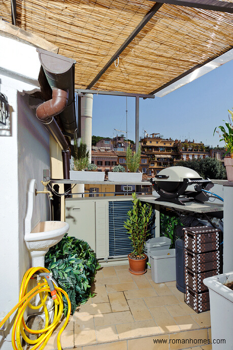 The side area of the terrace with the barbecue-external grill and the sink to clean dishes