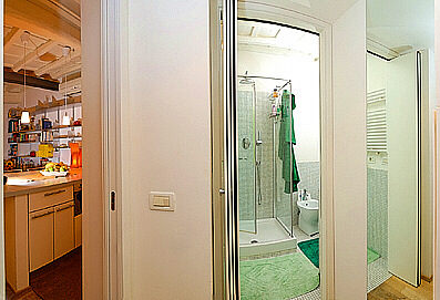 The corridor of the apartment with view of the bathroom