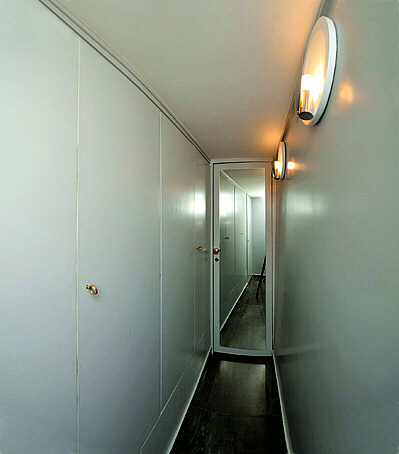 the corridor with wardrobes leading to the bathroom