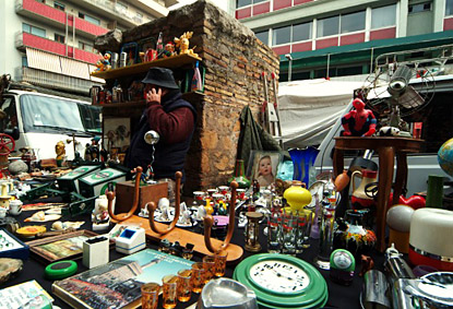 Porta portese stall vendor with cell phone telefonino