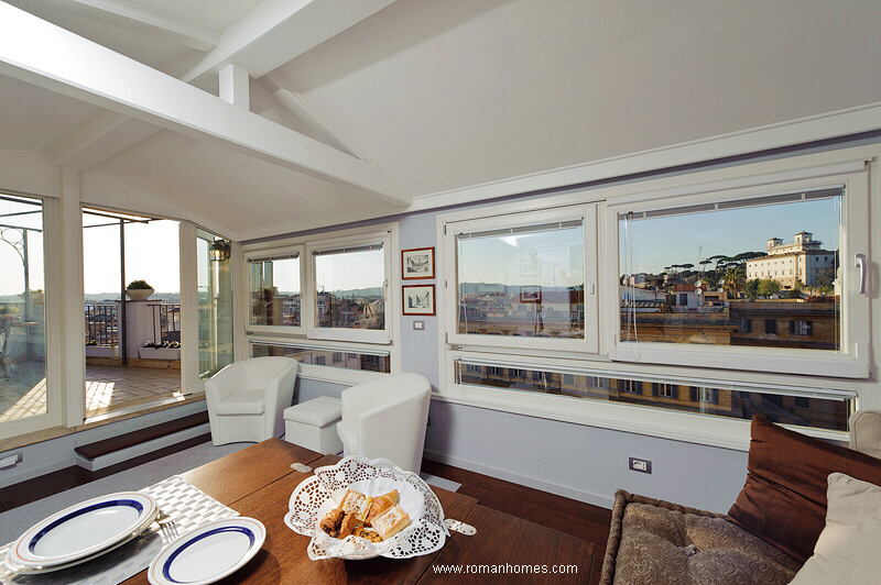 Sitting-dining room of the Spanish Steps Rome Seagulls penthouse with panoramic views